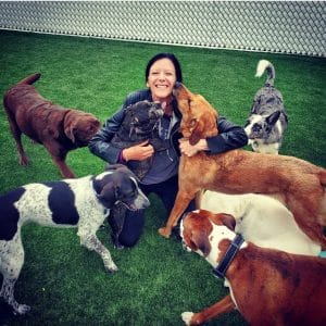 carolyn with dogs in play yard