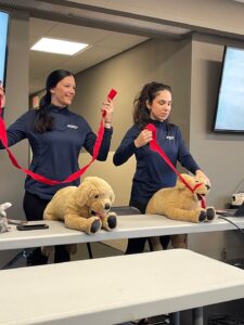 two fetch employees in pet first aid training